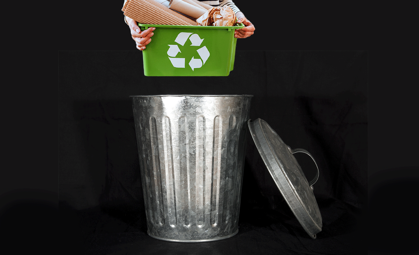 putting recycling in the trash 把可回收物品扔进垃圾桶