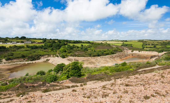 Abandoned mine and tailings dam at Wheal Maid Valley in Cornwall, England. 英国康沃尔郡惠尔少女谷废弃的矿山和尾矿坝。