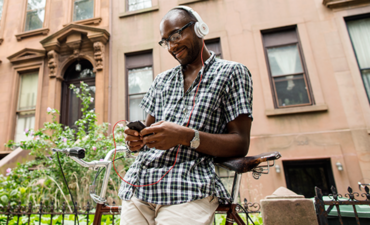 Man with a mobile phone wearing earbuds