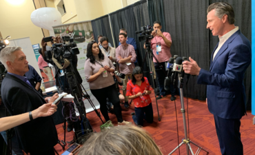California Gov. Gavin Newsom talks to a press gaggle at VERGE 19 in October in Oakland.