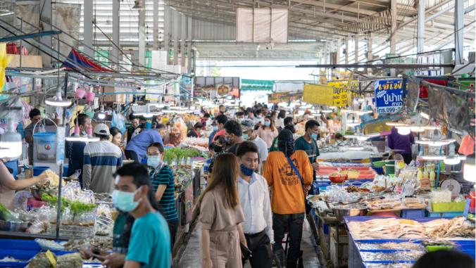 Local People walk and shop seafood at the Angsila fish market, the large fresh market in Chonburi Province, Thailand.